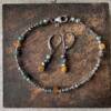 glimpse of gold bracelet and earrings